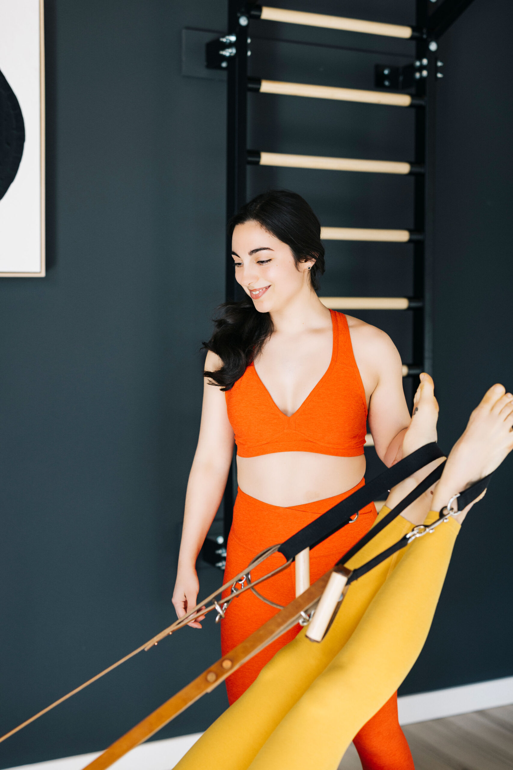 Tess teaching fee in straps on the Gratz reformer
